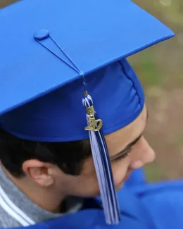person wearing blue academic hat by Foto Phanatic courtesy of Unsplash.